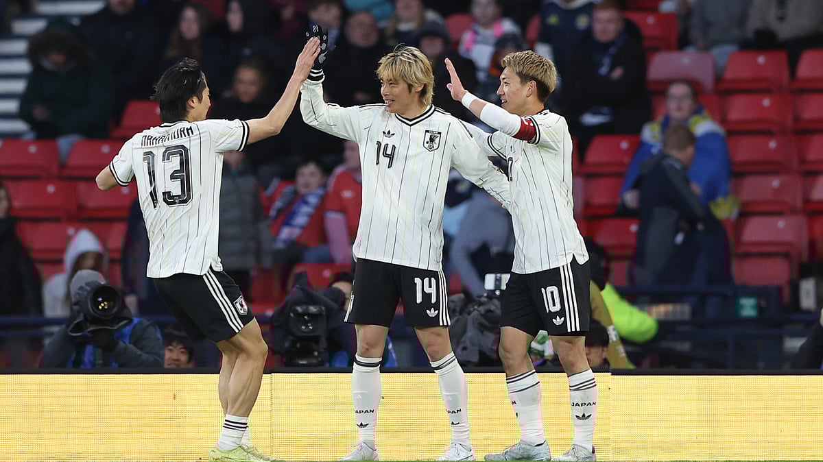 (AP Photo/Scott Heppell) : Japan's Junya Ito, centre, celebrates with Japan's Keito Nakamura, left, and Japan's Ritsu Doan after scoring his side's opening goal during the international friendly soccer match between Scotland and Japan in Glasgow, Scotland, Saturday, March 28, 2026.