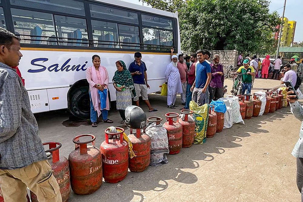 | Photo: PTI/Arvind Kumar : People queue up to avail LPG cylinders amid ongoing supply crunch, in Dilshad Colony, New Delhi.