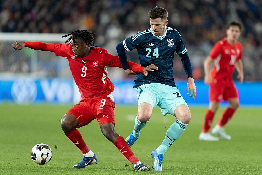 | Photo: Claudio Thoma/Keystone via AP : Switzerlands Johan Manzambi, left, shields the ball from Germanys Anton Stach, during an international friendly soccer match between Switzerland and Germany in Basel, Switzerland.