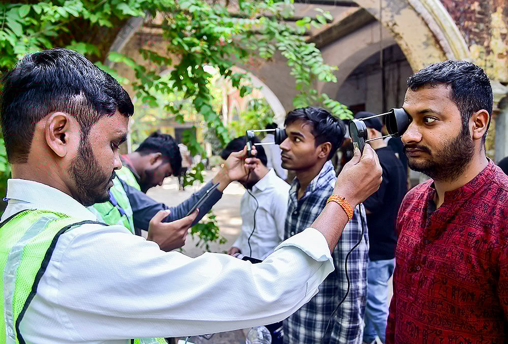 | Photo: PTI : Aspirants undergo security checks before they are allowed to appear for the Combined State/Upper Subordinate Services (PCS) Mains Examination 2025 conducted by the Uttar Pradesh Public Service Commission, in Prayagraj, Uttar Pradesh.