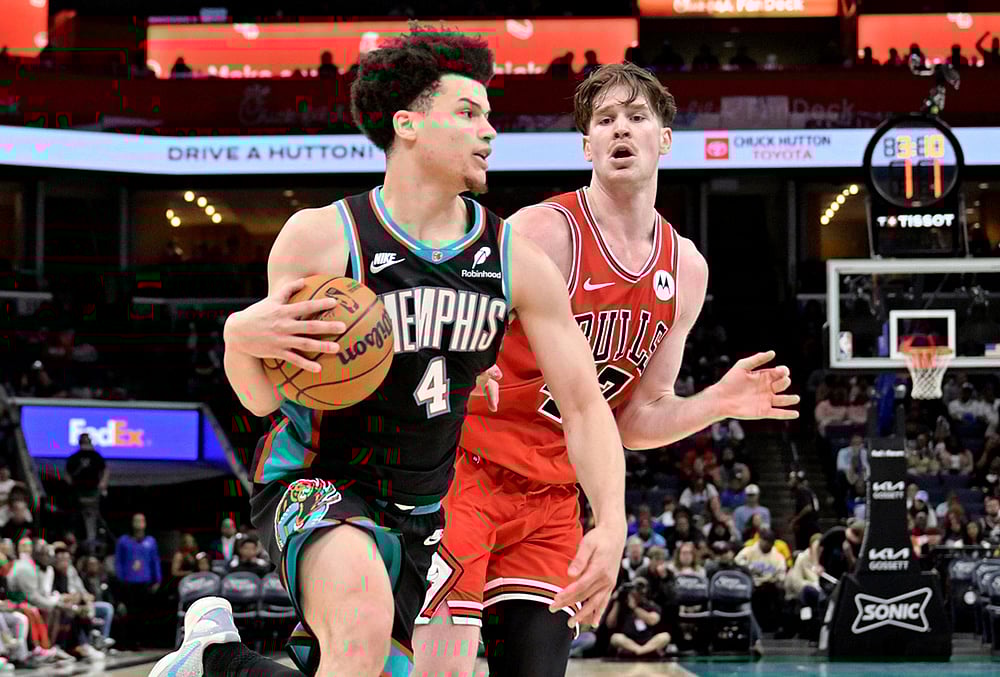 | Photo: AP/Brandon Dill : Memphis Grizzlies guard Walter Clayton Jr. (4) drives against Chicago Bulls center Lachlan Olbrich (47) in the second half of an NBA basketball game in Memphis, Tennessee. 