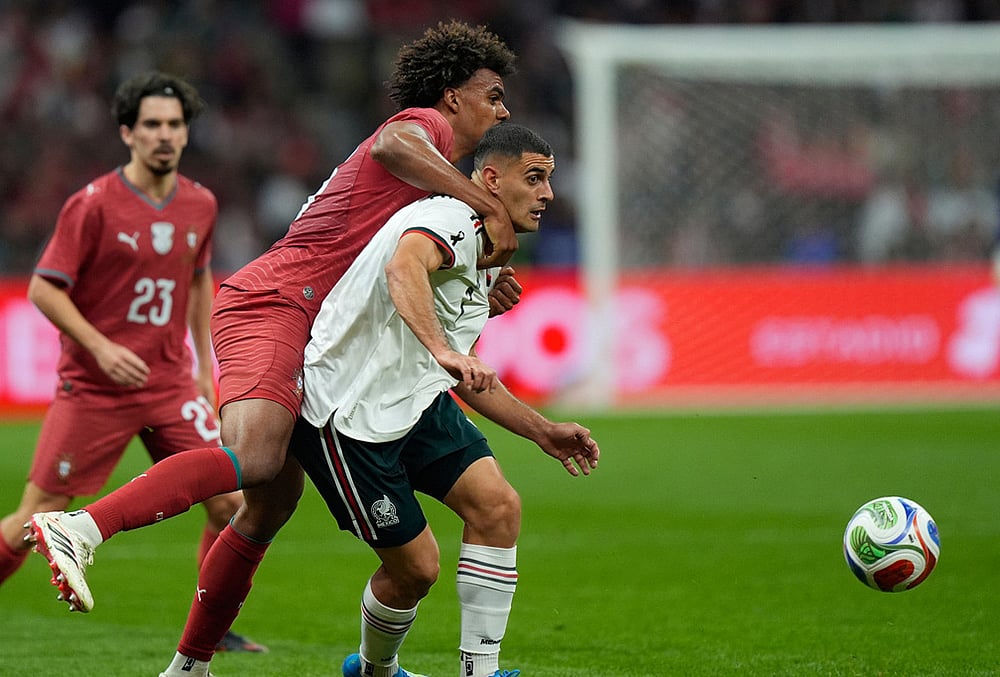 | Photo: AP/Fernando Llano : Mexicos German Berterame, right, is challenged by Portugals Renato Veiga during the international friendly soccer match between Mexico and Portugal in Mexico City.