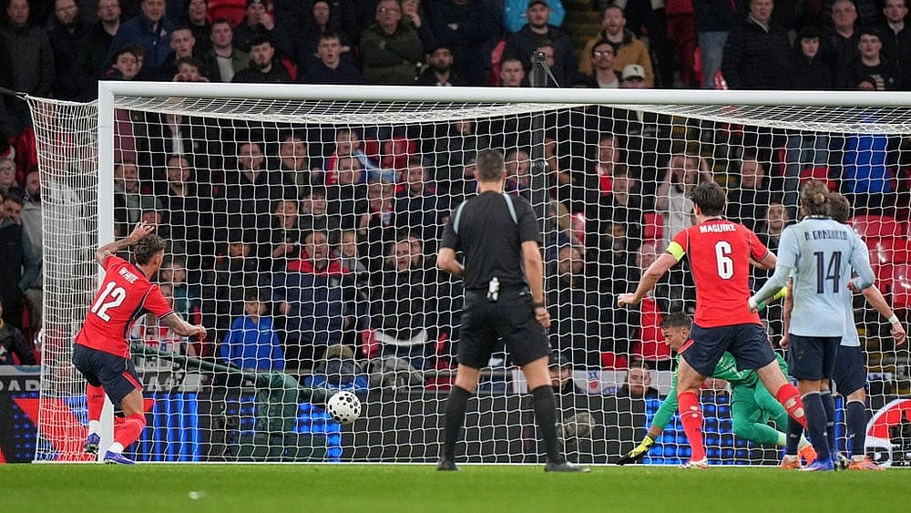 Photo: AP/Alastair Grant : England's Ben White, left, scores his side's opening goal during the international friendly soccer match between England and Uruguay in London.