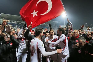 | Photo: AP/Visar Kryeziu : Turkey's players celebrate after winning the World Cup qualifying playoff final soccer match between Kosovo and Turkey in Pristina, Kosovo.