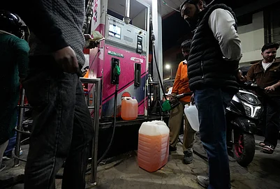 | Photo: AP/Mukhtar Khan : People store fuel in a plastic can at a petrol pump amid fears of a possible shortage due to the US Iran war, in Srinagar March 25, 2026.