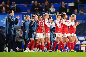 | Photo: John Walton/PA via AP : Arsenal players applaud fans after winning the Women's Champions League quarterfinal second leg soccer match against Chelsea in London.