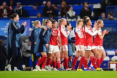 | Photo: John Walton/PA via AP : Arsenal players applaud fans after winning the Womens Champions League quarterfinal second leg soccer match against Chelsea in London.