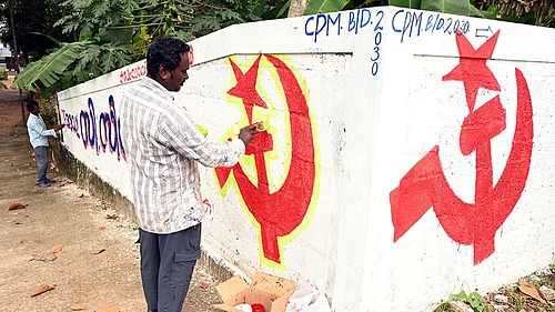 | Photo: PTI| Representative Image : Artists paint the LDF symbol on a wall as part of preparations for the upcoming Kerala local body elections, in Thiruvananthapuram.