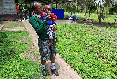 | Photo: AP/Andrew Kasuku : Valarie Wairimu, 19, interacts with her son, Kayden Darmain during breaktime at Greenland Girls School in Kiserian, Kajiado, Kenya.