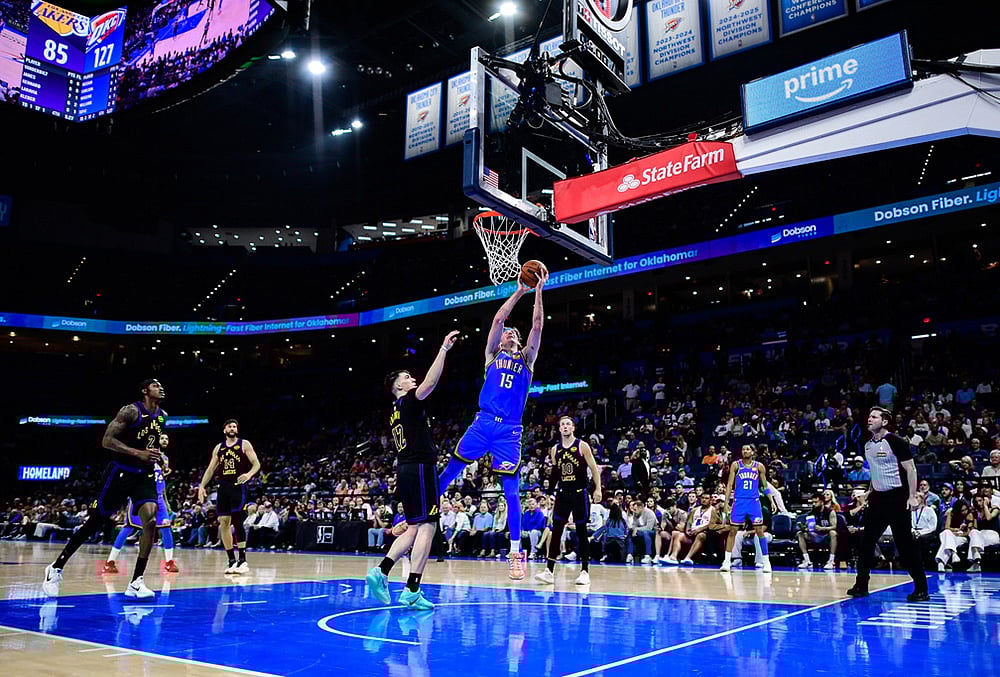 | Photo: AP/Gerald Leong : Oklahoma City Thunder center Branden Carlson (15) shoots against Los Angeles Lakers forward Jake LaRavia (12) during the second half of an NBA basketball game in Oklahoma City. 