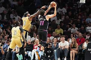 | Photo: AP/Marta Lavandier : Miami Heat forward Jaime Jaquez Jr. (11) aims to score as Washington Wizards guard Jaden Hardy (8) defends during the first half of an NBA basketball game in Miami.