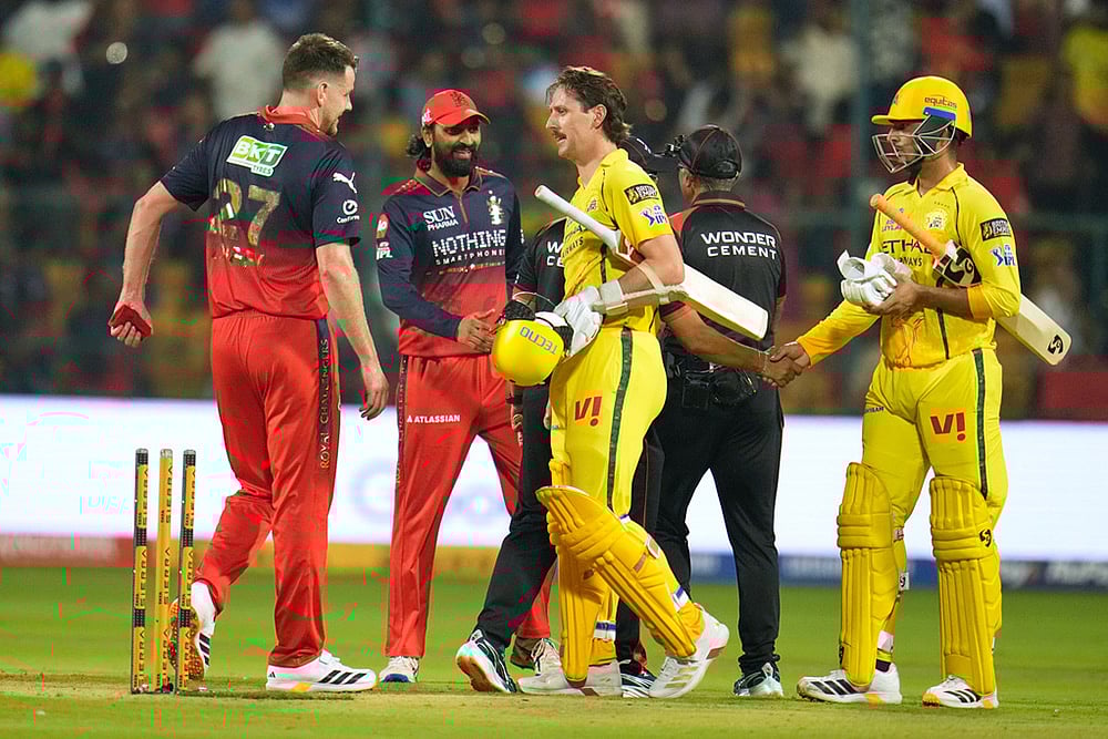 Photo: AP/Aijaz Rahi : Royal Challengers Bengalurus Jacob Duffy, left, walks to shake hands with Chennai Super Kings Matt Henry after Royal Challengers Bengaluru won the Indian Premier League cricket match against Chennai Super Kings in Bengaluru, India.