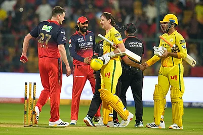 Photo: AP/Aijaz Rahi : Royal Challengers Bengalurus Jacob Duffy, left, walks to shake hands with Chennai Super Kings Matt Henry after Royal Challengers Bengaluru won the Indian Premier League cricket match against Chennai Super Kings in Bengaluru, India.
