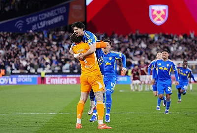 | Photo: John Walton/PA via AP : Leeds United goalkeeper Lucas Perri, left, celebrates with Pascal Struijk, top, and teammates after winning the penalty shoot-out during the English FA Cup quarterfinal soccer match between West Ham United and Leeds United, in London.