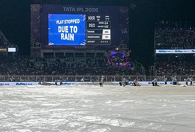 | Photo: PTI/Manvender Vashist Lav : Ground staff cover the ground during rain interruption in an Indian Premier League (IPL) 2026 cricket match between Kolkata Knight Riders and Punjab Kings at Eden Gardens, in Kolkata