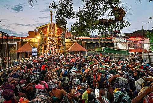 | Photo: PTI : Nine-judge constitution bench to hear review pleas on Tuesday, April 7, 2026, in a case related to the entry of women in the Sabarimala Temple. People are seen waiting to offer prayers at the temple, in Pathanamthitta district, Kerala, in this file photo dated Tuesday, Jan. 13, 2026.
