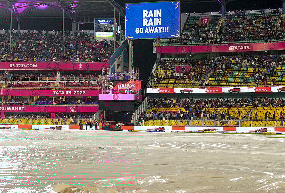 | Photo: PTI/Swapan Mahapatra : View of the ground covered due to rain during an Indian Premier League (IPL) 2026 T20 cricket match between Rajasthan Royals and Mumbai Indians, in Guwahati.