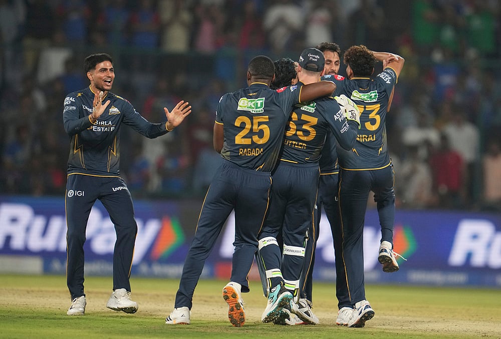 | Photo: AP/Manish Swarup : Gujarat Titans captain Shubman Gill, left, along with his teammates celebrates after they won the Indian Premier League cricket match against Delhi Capitals in New Delhi.