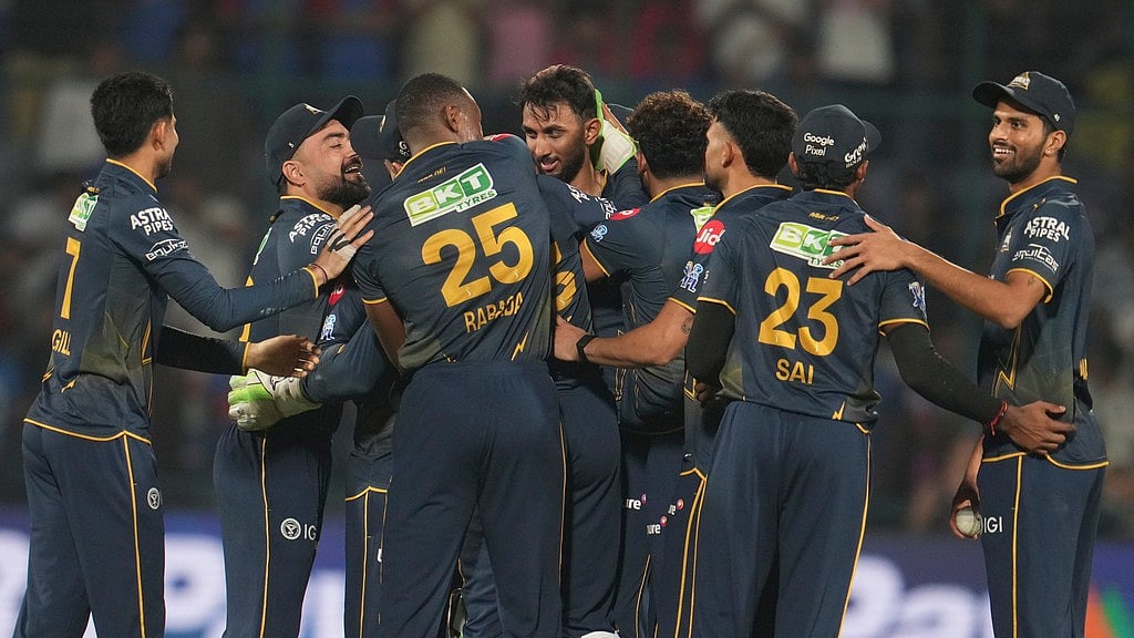 AP/Manish Swarup : Gujarat Titans Prasidh Krishna, centre, along with his teammates celebrates after they won the Indian Premier League match against Delhi Capitals in New Delhi.