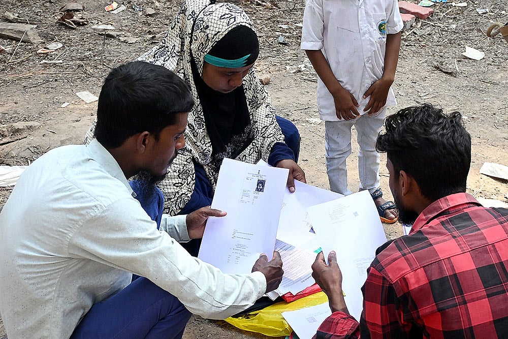 | Photo: PTI : People wait to submit their petitions before the Special Tribunal after their names were deleted from the Special Intensive Revision final voter list ahead of West Bengal Assembly Election, at Ranaghat, in Nadia district.