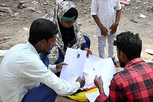| Photo: PTI : People wait to submit their petitions before the Special Tribunal after their names were deleted from the Special Intensive Revision final voter list ahead of West Bengal Assembly Election, at Ranaghat, in Nadia district.