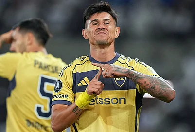 | Photo: AP/Esteban Felix : Adam Bareiro of Argentinas Boca Juniors celebrates after scoring his sides second goal against Chiles Universidad Catolica during a Copa Libertadores Group D soccer match in Santiago, Chile.