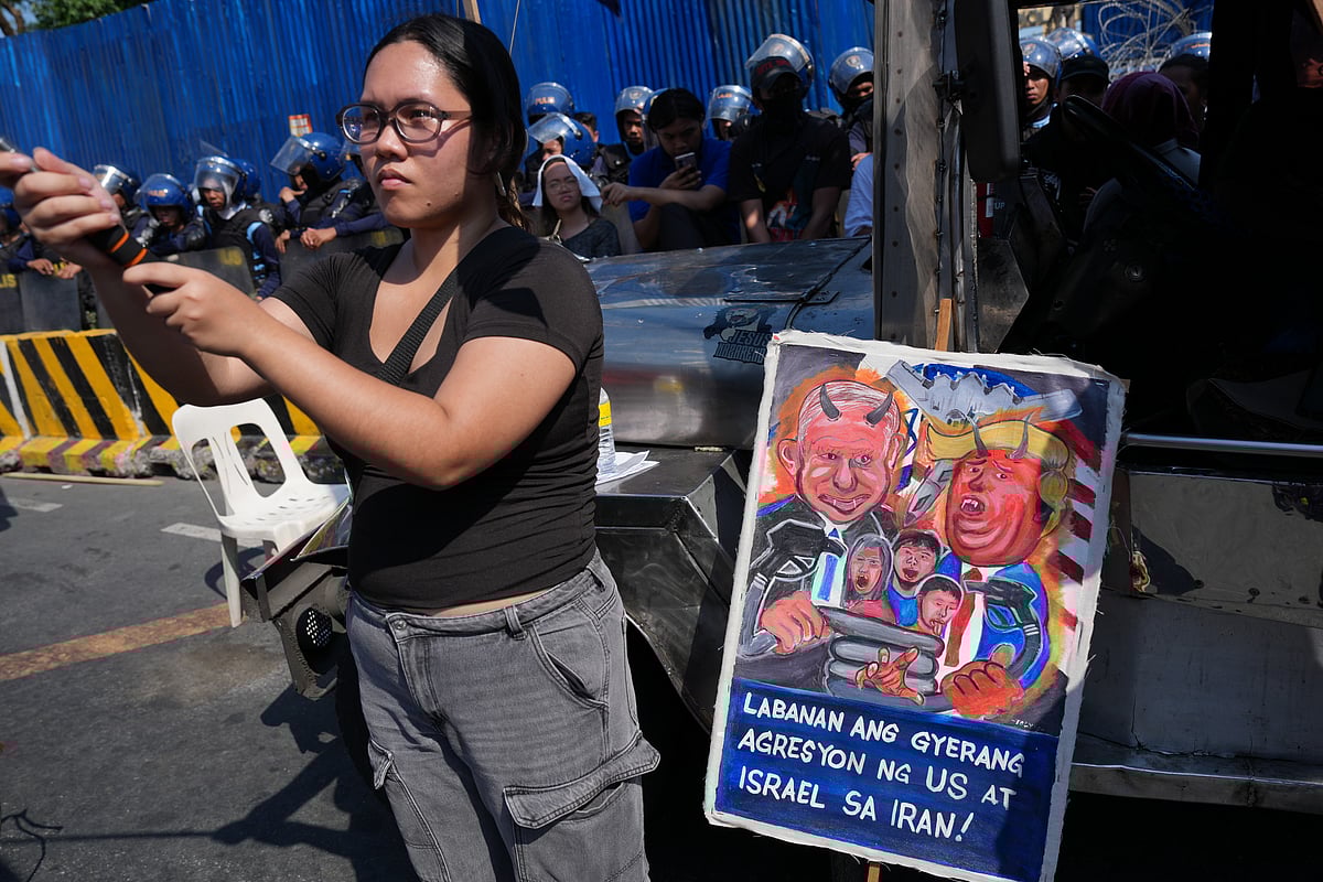 Aaron Favila : A protester stands beside a caricature of Israel Prime Minister Benjamin Netanyahu and U.S. President Donald Trump during a rally by transport workers and activists protesting the rise in oil prices on Friday, March 27, 2026, near the Malacanang presidential palace in Manila, Philippines.