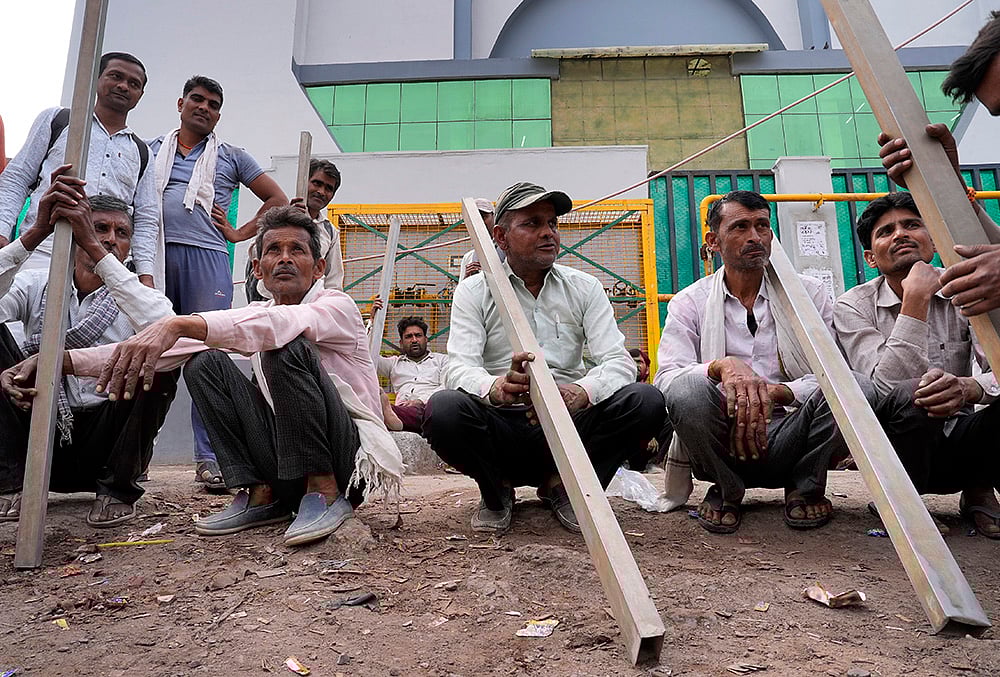 | Photo: Suresh K Pandey/Outlook : Daily-wage labourers in Noidas Khora Colony labour market, waiting to be hired for a days work.