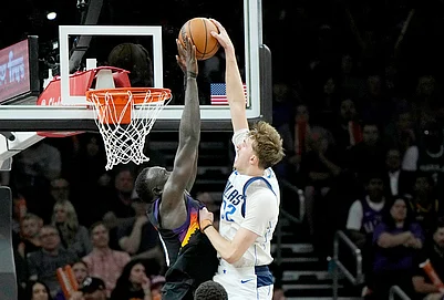 | Photo: AP/Ross D. Franklin : Dallas Mavericks forward Cooper Flagg (32) has his shot blocked by Phoenix Suns center Khaman Maluach, left, during the second half of an NBA basketball game in Phoenix.