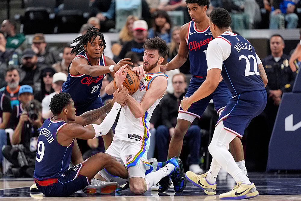 | Photo: AP/Mark J. Terrill : Oklahoma City Thunder center Chet Holmgren, center, battles for a loose ball with Los Angeles Clippers guard Bennedict Mathurin, left, and guard Tyty Washington Jr., second from left, as guard Cam Christie, second from right, and guard Jordan Miller watch during the second half of an NBA basketball game  in Inglewood, Calif.