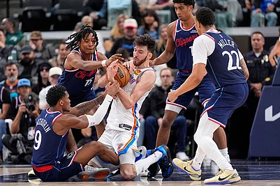 | Photo: AP/Mark J. Terrill : Oklahoma City Thunder center Chet Holmgren, center, battles for a loose ball with Los Angeles Clippers guard Bennedict Mathurin, left, and guard Tyty Washington Jr., second from left, as guard Cam Christie, second from right, and guard Jordan Miller watch during the second half of an NBA basketball game in Inglewood, Calif.