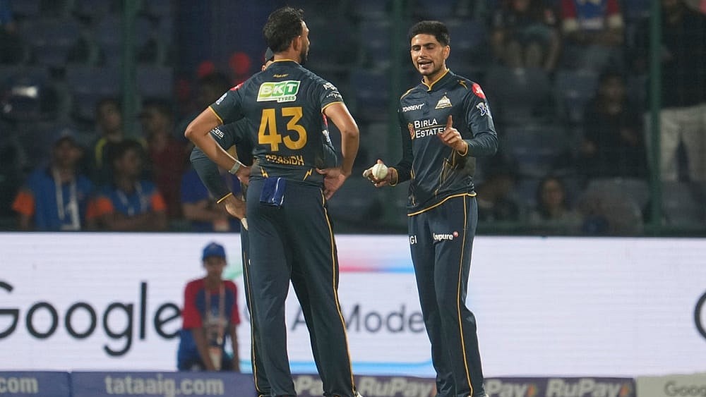 | Photo: AP/Manish Swarup : Gujarat Titans captain Shubman Gill, right, talks to his team bowler Prasidh Krishna during the Indian Premier League cricket match between Delhi Capitals and Gujarat Titans in New Delhi.