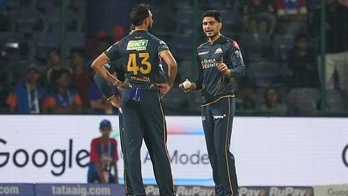 | Photo: AP/Manish Swarup : Gujarat Titans captain Shubman Gill, right, talks to his team bowler Prasidh Krishna during the Indian Premier League cricket match between Delhi Capitals and Gujarat Titans in New Delhi.