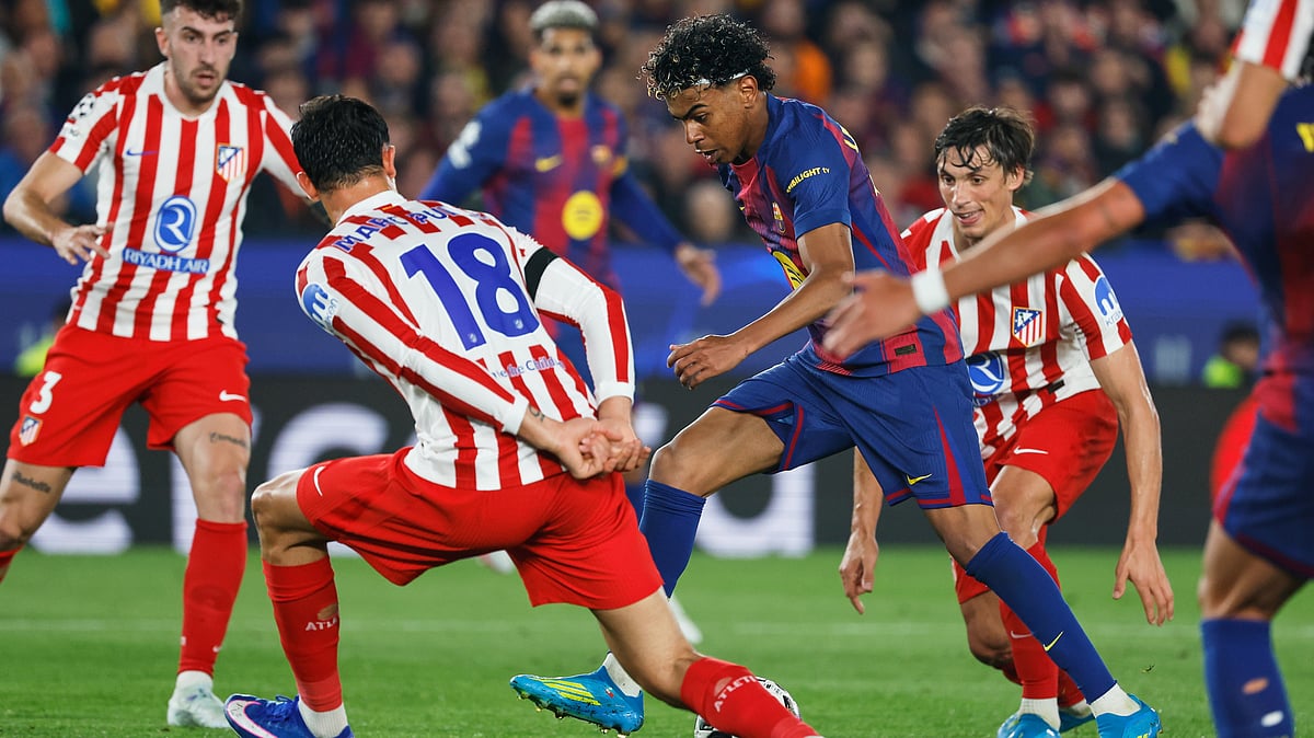 | Photo: AP/Joan Monfort : Barcelonas Lamine Yamal challenges for the ball with Atletico Madrids Marc Pubill during the Champions League quarterfinal first leg soccer match between Barcelona and Atletico Madrid in Barcelona, Spain, Wednesday, April 8, 2026. 