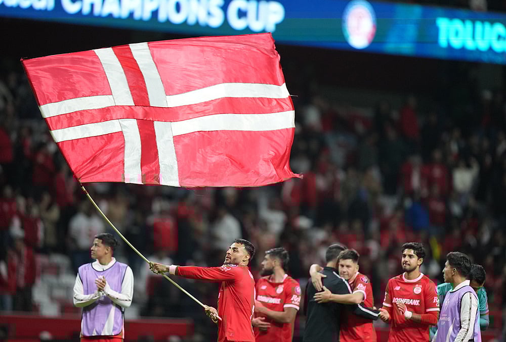 | Photo: AP/Fernando Llano : Alexis Vega of Mexicos Toluca waves a flag after a CONCACAF Champions Cup quarterfinal first leg soccer match against the United States LA Galaxy in Toluca, Mexico.
