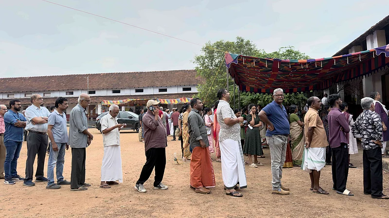 Photo: AP/ R S Iyer : People queue up to vote outside a polling booth during the Kerala state election in Kochi, India, Thursday, April 9, 2026.