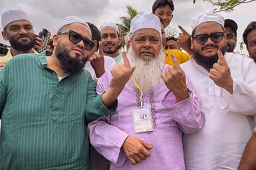 Photo: PTI : All India United Democratic Front (AIUDF) president and candidate from Binnakandi constituency, Maulana Badruddin Ajmal, shows his ink-marked finger after casting a vote in the Assam Assembly elections, in Binnakandi.
