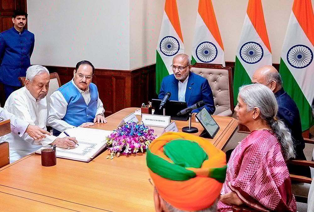 | Photo: @CPR_VP/X via PTI : Vice President and Rajya Sabha Chairman CP Radhakrishnan administers oath to Bihar Chief Minister Nitish Kumar as a member of the House during a ceremony at the formers chamber at the Parliament House complex, in New Delhi. Union Ministers JP Nadda and Nirmala Sitharaman are also seen. 