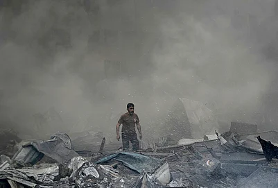 | Photo: AP/Bilal Hussein : A first responder emerges through the smoke at the site of an Israeli airstrike that struck an apartment building in Beirut, Lebanon, Wednesday, April 8, 2026.