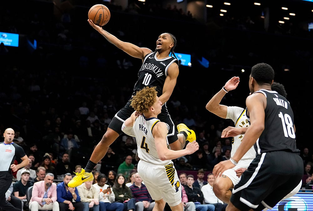 | Photo: AP/Yuki Iwamura : Brooklyn Nets guard Tyson Etienne (10) goes up to shoot over Indiana Pacers guard Taelon Peter (4) during the second half of an NBA basketball game in New York. 