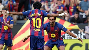 Photo: AP/Joan Monfort : Barcelona's Ferran Torres, right, celebrates after scoring the opening goal with Lamine Yamal during the Spanish La Liga match between Barcelona and Espanyol in Barcelona.