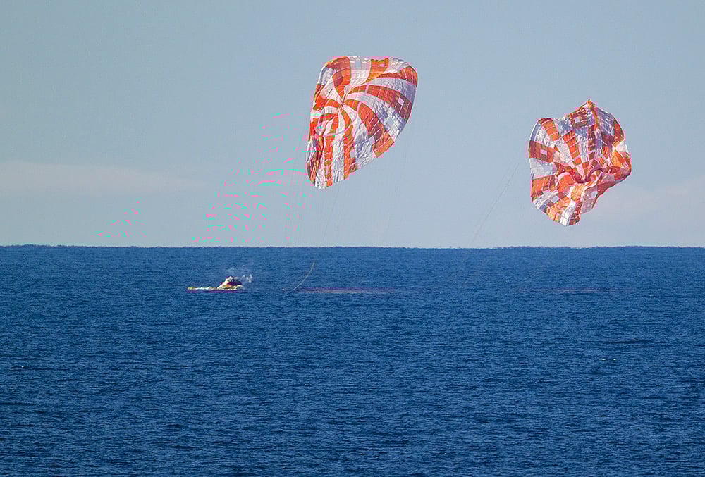| Photo:  NASA via PTI : The Orion spacecraft carrying Artemis II crew members Reid Wiseman, Victor Glover, Christina Koch and Jeremy Hansen, unseen, splashes down in the Pacific Ocean off the coast of California, USA. 