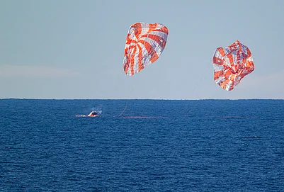 | Photo: NASA via PTI : The Orion spacecraft carrying Artemis II crew members Reid Wiseman, Victor Glover, Christina Koch and Jeremy Hansen, unseen, splashes down in the Pacific Ocean off the coast of California, USA.