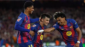AP/Joan Monfort : Marcus Rashford, left, celebrates after scoring his side's fourth goal with Lamine Yamal, right, and Pedri during the La Liga match between Barcelona and Espanyol in Barcelona.