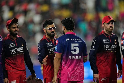 Photo: AP/Anupam Nath : Royal Challengers Bengalurus Virat Kohli and Rajasthan Royals captain Riyan Parag shake hands at the end of the Indian Premier League cricket match between Royal Challengers Bengaluru and Rajasthan Royals in Guwahati, India.