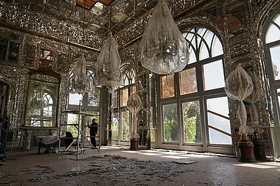 Photo: AP/Francisco Seco : Broken glass lies on the floor beneath chandeliers covered in protective plastic in a room damaged, according to Iranian authorities, by a nearby airstrike during U.S.-Israeli strikes in early March at the Golestan Palace, a UNESCO World Heritage site, in Tehran, Iran.