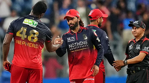 AP Photo/Rafiq Maqbool : Royal Challengers Bengalurus Devdutt Padikkal with teammates celebrate the win over Royal Challengers Bengaluru during the Indian Premier League cricket match, in Mumbai , India, Sunday, April 12, 2026.