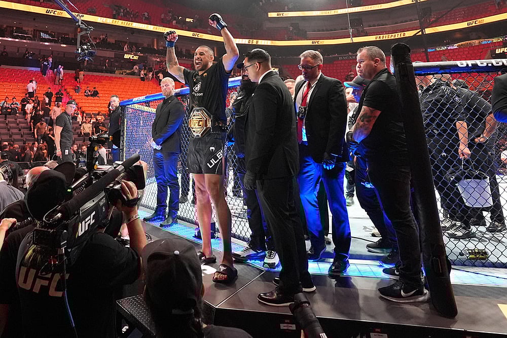 | Photo: AP/Rebecca Blackwell : Carlos Ulberg, center left, of New Zealand, celebrates after defeating Jiri Prochazka, of Czechia, by TKO to win their light heavyweight title bout at a UFC 327 mixed martial arts event in Miami.