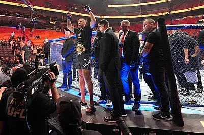 | Photo: AP/Rebecca Blackwell : Carlos Ulberg, center left, of New Zealand, celebrates after defeating Jiri Prochazka, of Czechia, by TKO to win their light heavyweight title bout at a UFC 327 mixed martial arts event in Miami.