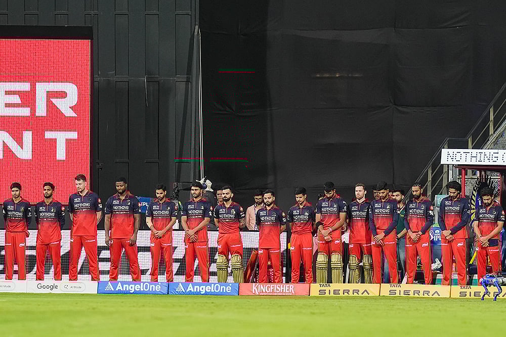 | Photo: PTI/Kunal Patil : Players of Royal Challengers Bengaluru observe a moment of silence in memoriam of singing legend Asha Bhosle, before an Indian Premier League (IPL) 2026 T20 cricket match between Mumbai Indians and Royal Challengers Bengaluru, in Mumbai, Maharashtra. Bhosle, Indias beloved singing icon, died at the age of 92 on Sunday following multiple organ failure, doctors treating her said.